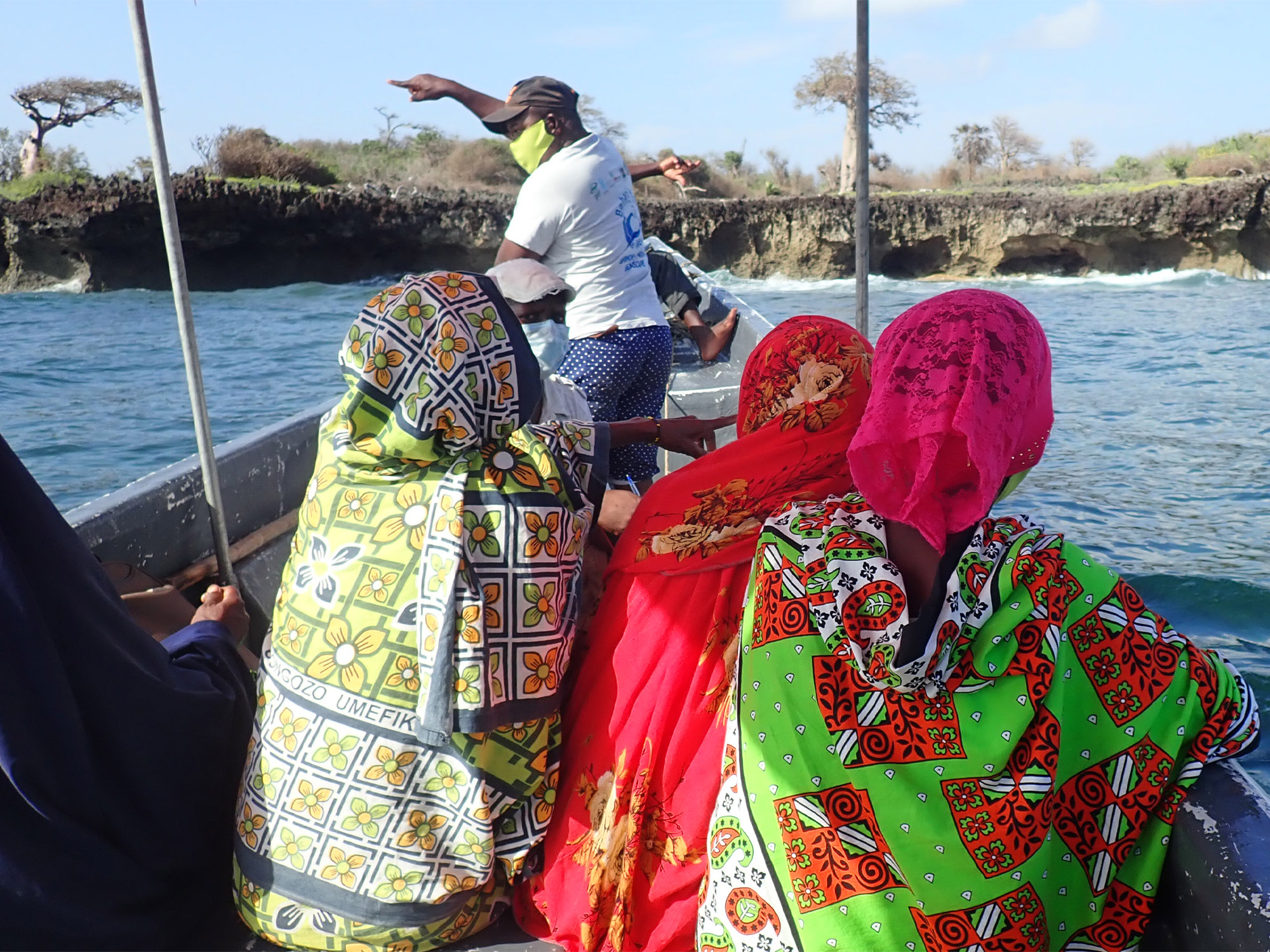 Women take a boat ride as part of a Ground Truthing visit.