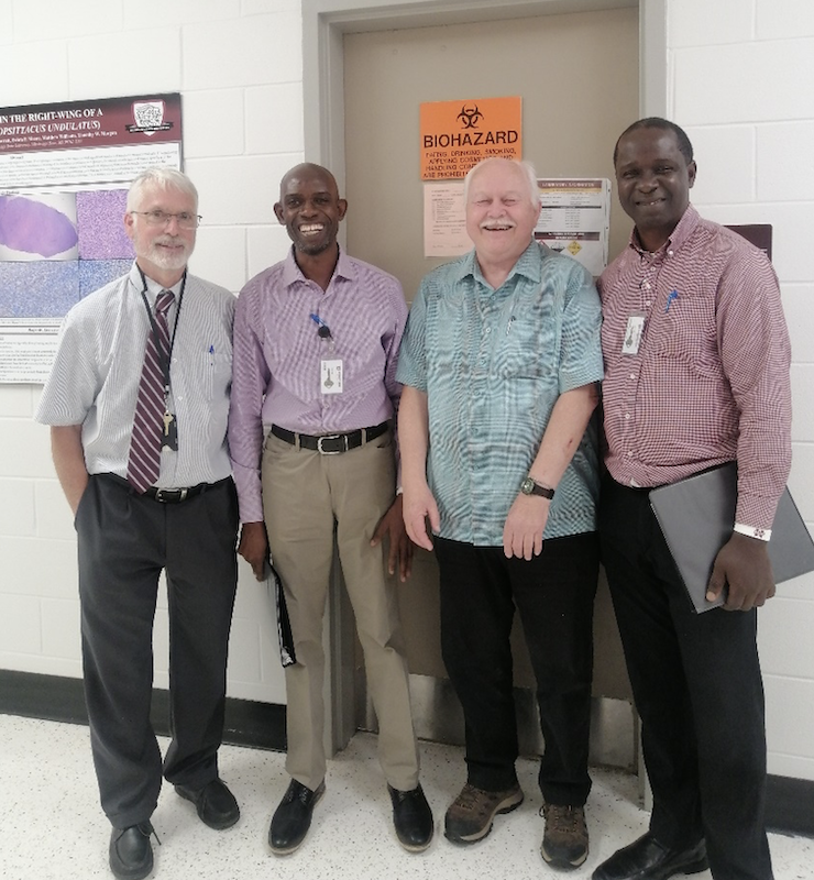Larry Hanson, Selim Alarape, Jack Skip, and Oluwasanmi Aina stand outside the Fish Diagnostic Laboratory in the College of Veterinary Medicine at Mississippi State University. Photo by Lorelei Ford