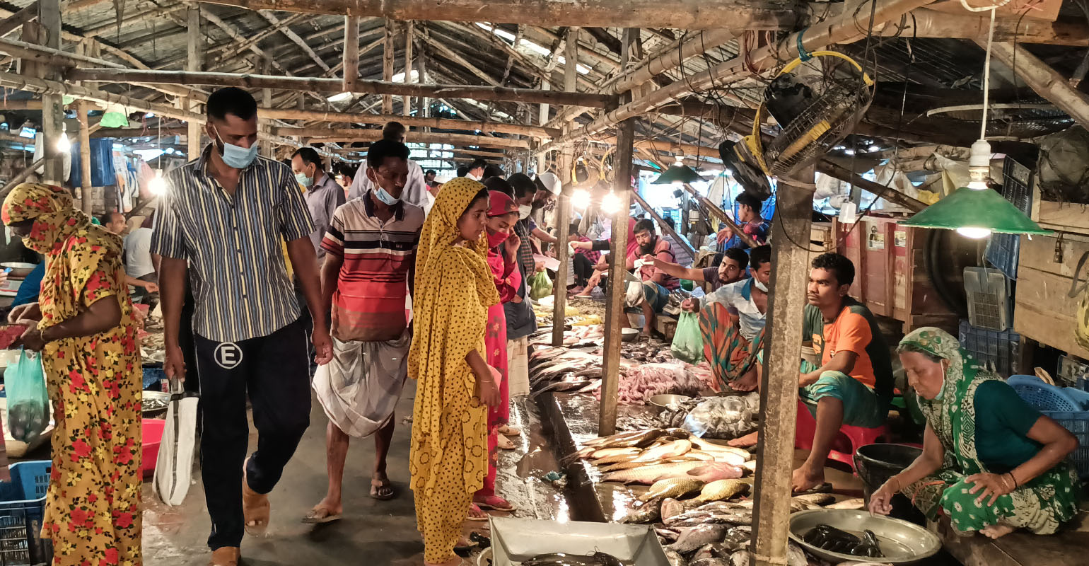 People buying fish at a market in Bangladesh